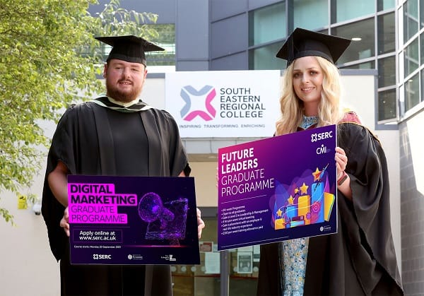 Two graduates, one male and one female, in gowns promote new graduate programmes at SERC.